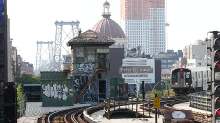 New York City, United States - 7 Sept 2023: Subway station. Metro train, public transportation platform. Elevated outdoor NYC railway Marcy Av, Brooklyn passenger railroad traffic, Williamsburg Bridgeのeditorial素材