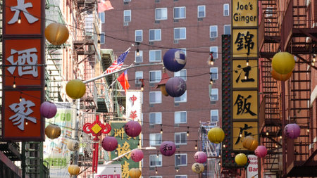 New York City, United States - 14 Sept 2023: Manhattan Chinatown Pell street. Chinese culture, ethnic district architecture, USA. Red brick buildings, paper lanterns and hieroglyph signs. Little Chinaのeditorial素材