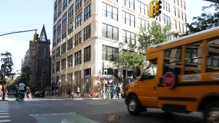 New York City, United States - 6 Sept 2023: Yellow School Bus on Manhattan street, schoolbus, taxi...