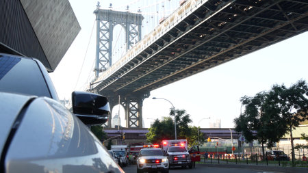 New York City, United States - 7 Sept 2023: NYFD Ambulance medical emergency, fire department paramedic truck. Manhattan bridge. Police patrol car, USA NYPD 911 vehicle on street. American cop siren.のeditorial素材