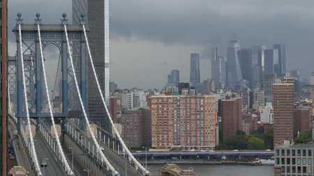 Manhattan bridge from above, rooftop in Brooklyn Dumbo, New York, United States. City traffic on transport bridge aerial view, cars on road. Hudson Yards district skyscrapers, towers on rainy day.の写真素材