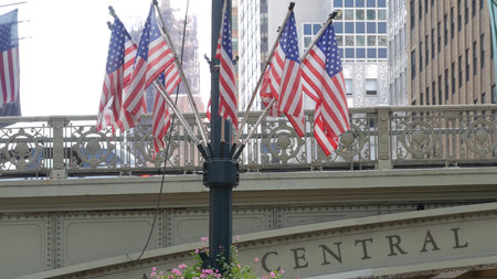 American flags near Grand Central Terminal on 42 street, New York City, Manhattan Midtown. Bridge to...