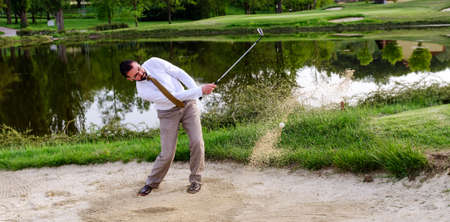 Businessman Golfer in Sand trapの写真素材
