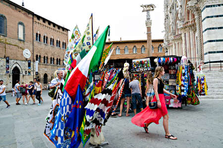 Siena, Italy - June 29, 2014: selling flags to the Palio of Siena, in a kiosk in the square of the cathedral Italy. Medieval horse races the Palio of Siena in Tuscan Italy.のeditorial素材