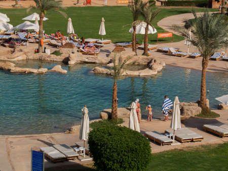 Sharm elSheikh Egypt  February 27 2013: tourists tan in the sun by the pool of a resort of Sharm elSheikh in Egypt.のeditorial素材