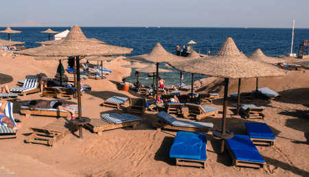 Sharm elSheikh Egypt  March 02 2013: tourists on the beach in Sharm elSheikh under the umbrella on the cliffs of coral reefsのeditorial素材