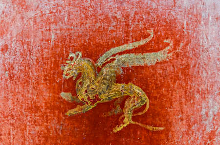 detail of the fresco in Pompeii with winged griffin on a red background PompeianPompeii is a ruined and partially buried Roman towncity near modern Naples in the Italian region of Campania in the territory of the comune of Pompei. Along with Herculaneum iのeditorial素材