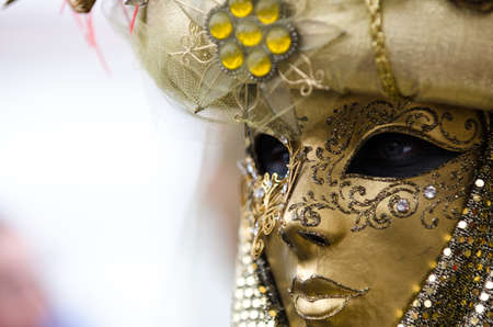Venice, Italy - February 26th, 2011: A beautiful lady in gold decorated Carnival dress, during the Carnival in Piazza San Marcoのeditorial素材