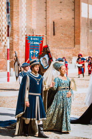 Asti, Italy - September 16, 2012: pair of noblemen in medieval costumes in historical parade on the day of the Palio in Asti, Italyのeditorial素材