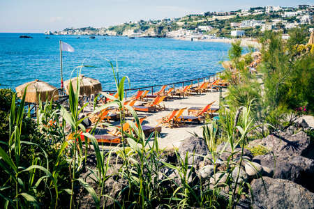 chairs and umbrella on a beautiful beachの写真素材
