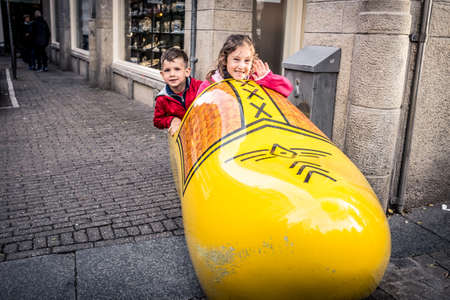 Children sitting in the big Dutch clog the streets of Amsterdam in the Netherlands