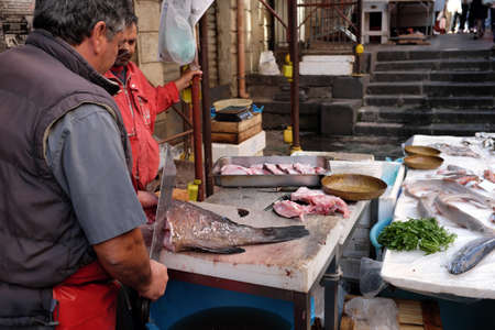 Catania, Italy - October 23, 2015: Fisherman selling swordfish to the fish market in Catania, Italy. the historic fish market of Catania in Piazza Alonzo di Benedetto was created in 1814 by digging the embankment of the sixteenth-century walls, is today oのeditorial素材