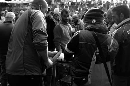 Catania, Italy - October 23, 2015: Fisherman selling swordfish to the fish market in Catania, Italy....