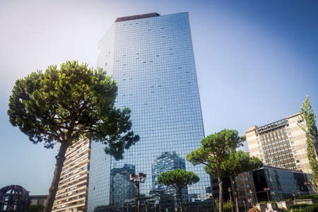 view of modern skyscrapers in business district against blue skyの写真素材