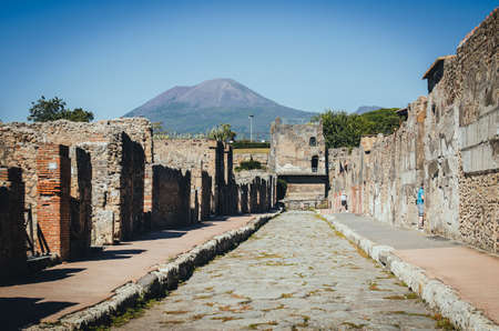 Tower of Mercury with Volcano Mount Vesuvius in the background, Pompeii.  Pompeii was destroyed by the eruption of the volcano Vesuvius in AD 79.の写真素材