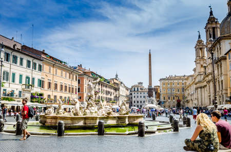 Roma, Italy - June 29, 2016: Tourist in Piazza Navona with the St. Agnes in Agone church in Rome. The fountain in the foreground is the "Fountain of the Moor."のeditorial素材
