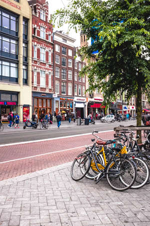 Amsterdam , Netherland 2016- 06- 16: Amsterdam people stroll along the damrakのeditorial素材