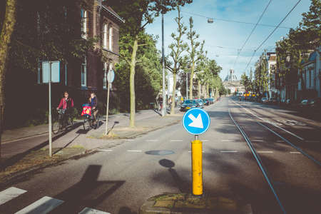 June 2016: Amsterdam, Netherlands. Girls on bikes on the bike path in Amsterdam, Netherlands. Urban...