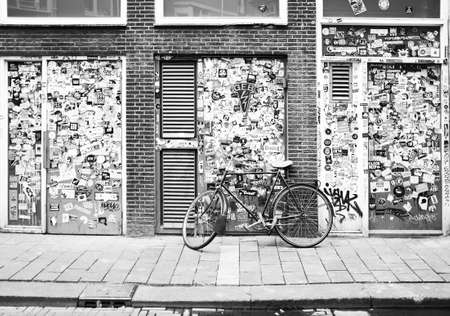 Amsterdam, Netherlands 06-16-2016: motorcycle parked in the street in Amsterdam, the background and covered with advertising stickers Forming an Effect storyline,のeditorial素材