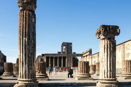 Pompeii, Italy 03 october 2013: tourists in the ancient Roman Basilica of the archaeological site of Pompeii with Vesuvius in the background. Naples Italyのeditorial素材