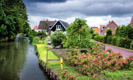Typical house on canal in Volendam, Netherlandsの写真素材