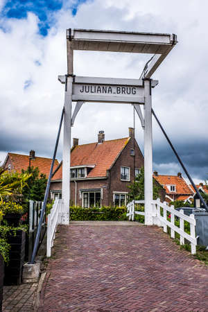 Netherlands, the small movable bridge and canal in the village of Volendamのeditorial素材