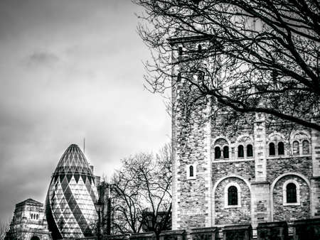 View of Gherkin building and Tower of London Walls - historic castle on north bank of River Thames. Gherkin skyscraper - iconic symbol of London.の写真素材