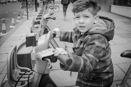 Child with a public bicycle rental for touristsの写真素材