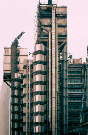 The exterior stairs and large pipes of a modern commercial buildingの写真素材