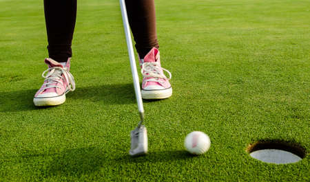 Pink Golfer teen goes in the holeの写真素材