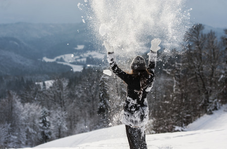 Woman enjoying in snow.の写真素材