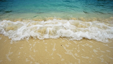 Beach wave sea sand sun water in thailand beach for background and designの写真素材
