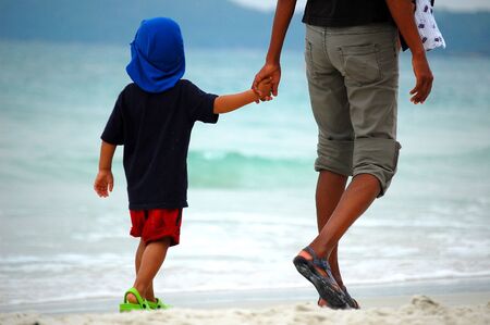 Mom and son on the beachの写真素材