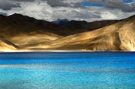 Lake on himalayas with high snow mountainの写真素材