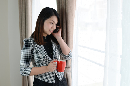 Business woman using with mobile phoneの写真素材