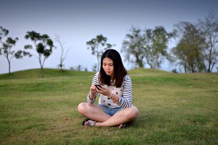 Young girl touching smart phone for check social networkの写真素材