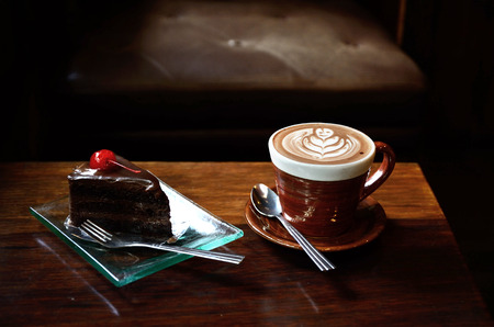 Coffee and cake on wood table in vintage coffee shopの写真素材