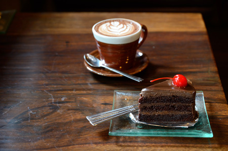 Coffee and cake on wood table in vintage coffee shopの写真素材
