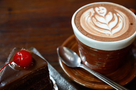 Coffee and cake on wood table in vintage coffee shopの写真素材