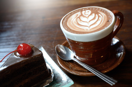 Coffee and cake on wood table in vintage coffee shopの写真素材