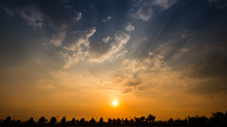 Sunset or sunrise with cloud and ray light on blue skyの写真素材