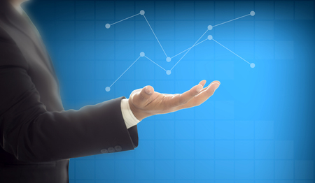 Businessman holding graph digital graphic on hand , business conceptの写真素材