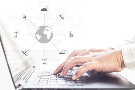 Businessman hands using laptop and mobile phone with social network diagram , communication network conceptの写真素材