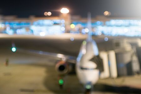 Airport blurred background at night time with aircraft