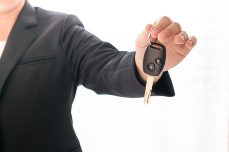 saleswoman holding car keyの写真素材