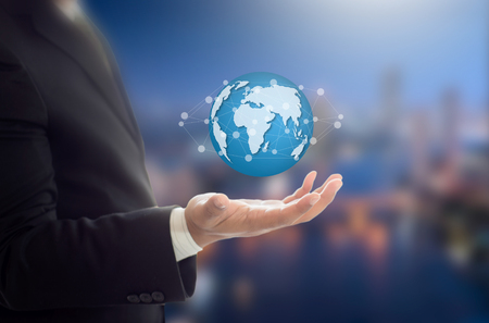 Businessman holding Earth graphic on hand , communication and network internet conceptの写真素材