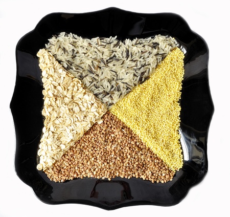 Black plate with rice, buckwheat, millet, porridge frome aboveの写真素材