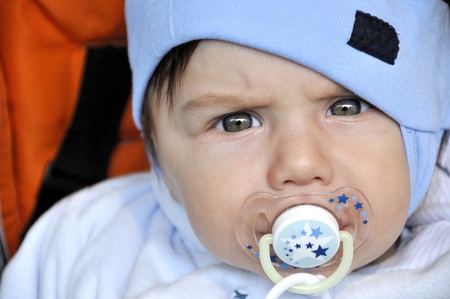 Serious looking baby with dummy