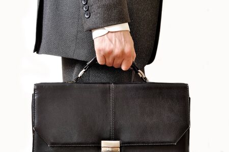 Shabby black leather briefcase in male handの写真素材