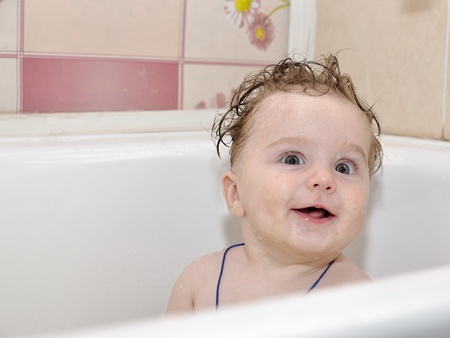 Sitting baby in bath smilingの写真素材